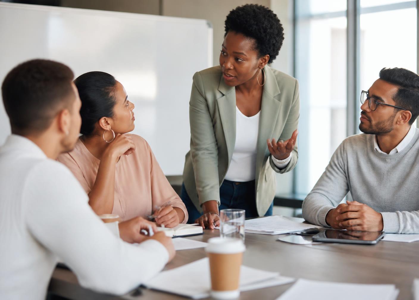 A Black woman HR leader facilitating a manager training session